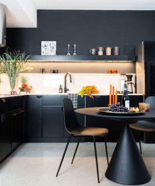 small kitchen with black cabinets and walls