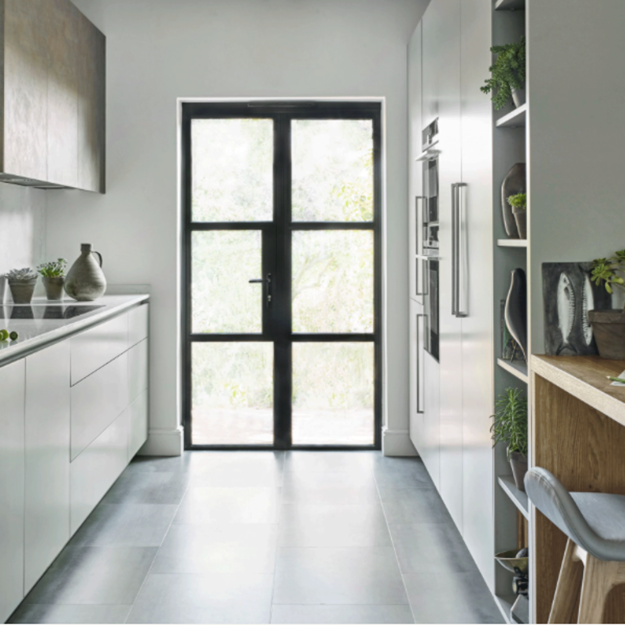 White galley kitchen with glazed door at one end