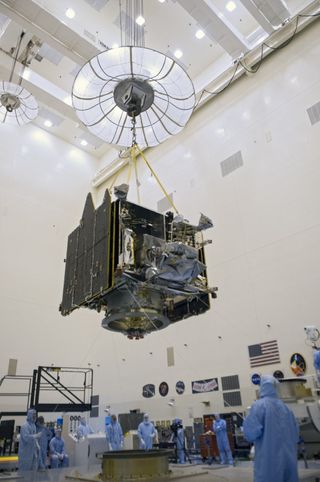 A crane lifts NASA's Mars Atmosphere and Volatile Evolution (MAVEN) spacecraft inside the Payload Hazardous Servicing Facility on Aug. 3, 2013, at the agency’s Kennedy Space Center in Florida.