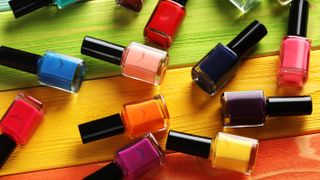 An assortment of nail polish colors on a wooden surface