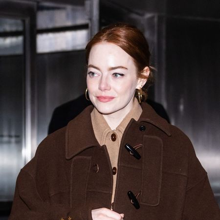 Emma Stone wearing a brown coat