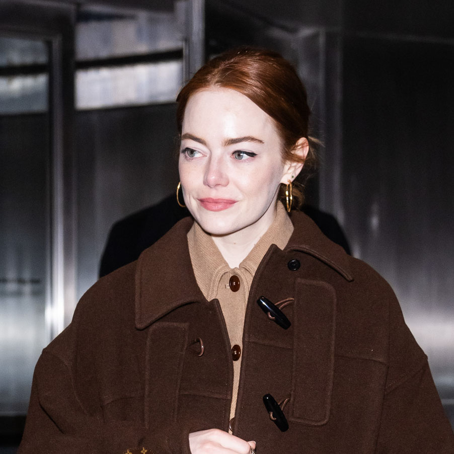 Emma Stone wearing a brown coat