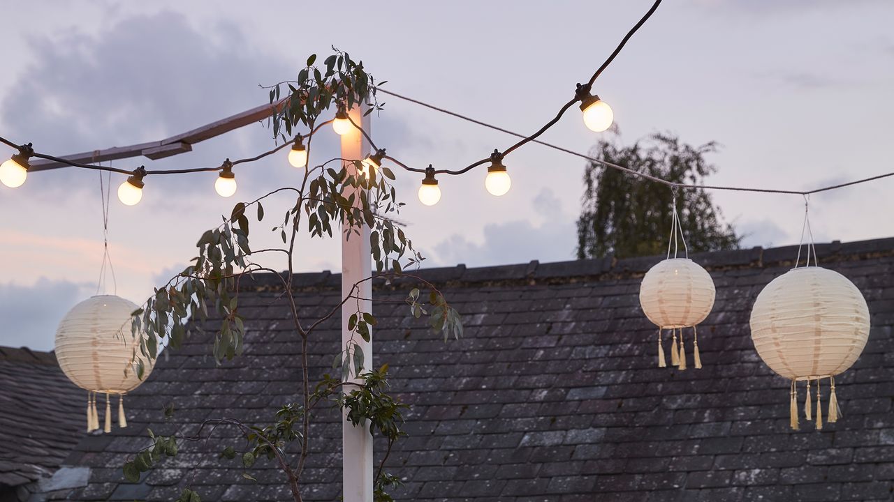 Roof terrace covered with faux candles, lanterns and festoon lighting