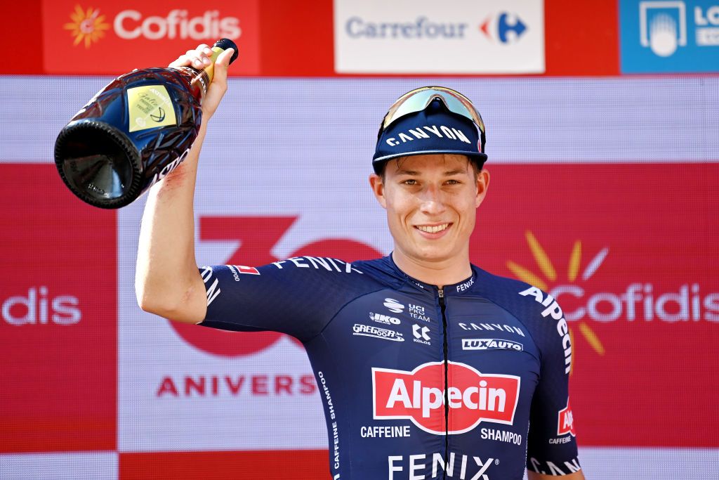 BURGOS SPAIN AUGUST 15 Jasper Philipsen of Belgium and Team AlpecinFenix celebrates winning the stage on the podium ceremony after the 76th Tour of Spain 2021 Stage 2 a 1667km stage from Caleruega Monasterio de Santo Domingo de Guzmn to Burgos Gamonal lavuelta LaVuelta21 CapitalMundialdelCiclismo on August 15 2021 in Burgos Spain Photo by Stuart FranklinGetty Images