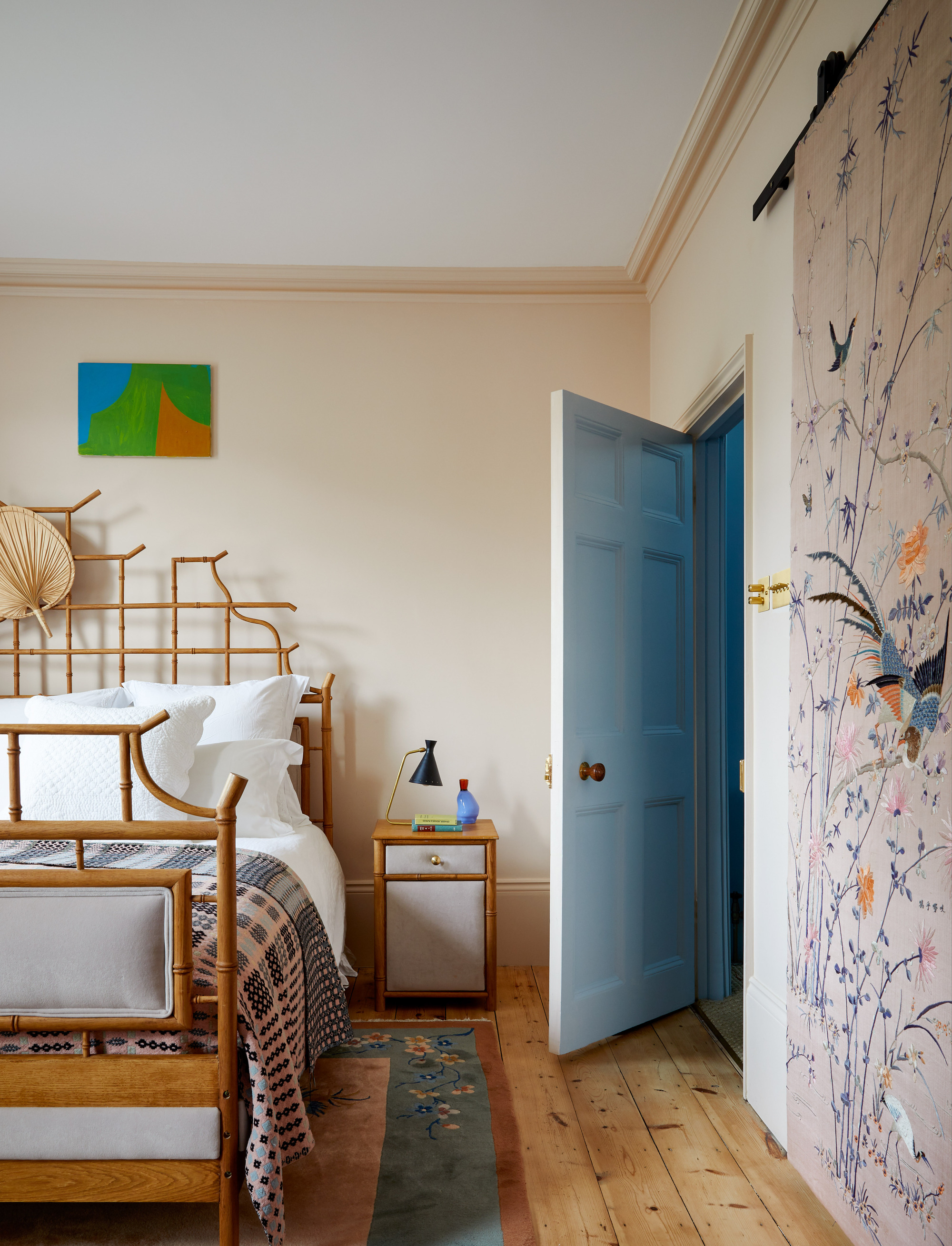 Rachel Chudley designed small bedroom in a London townhouse with a cane bedframe and wall hanging