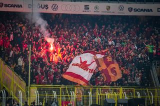 Galatasaray fans light flares during a derby against Fenerbahce in December 2023.