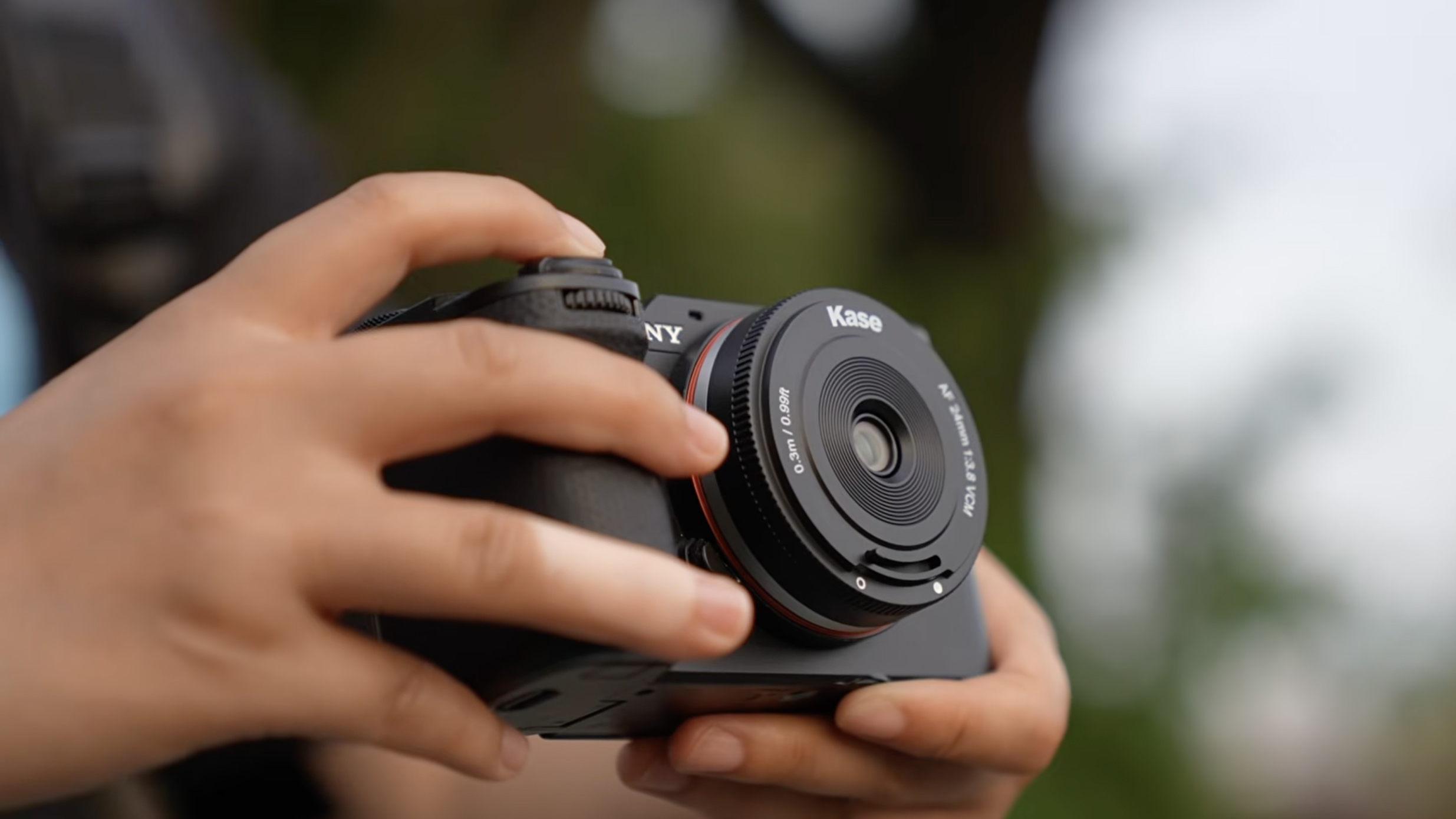 A photo of the Kase AF 24mm f/3.8 mounted on a Sony camera
