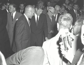S62-03987 (11 September 1962) --- Astronaut John H. Glenn, Jr., gives United States President John F. Kennedy a quick run-down on the display of survival gear. The Chief Executive took a quick tour of a dozen NASA displays set up for him after the classif