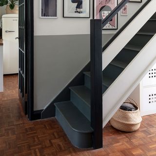 room with grey staircase and wooden flooring