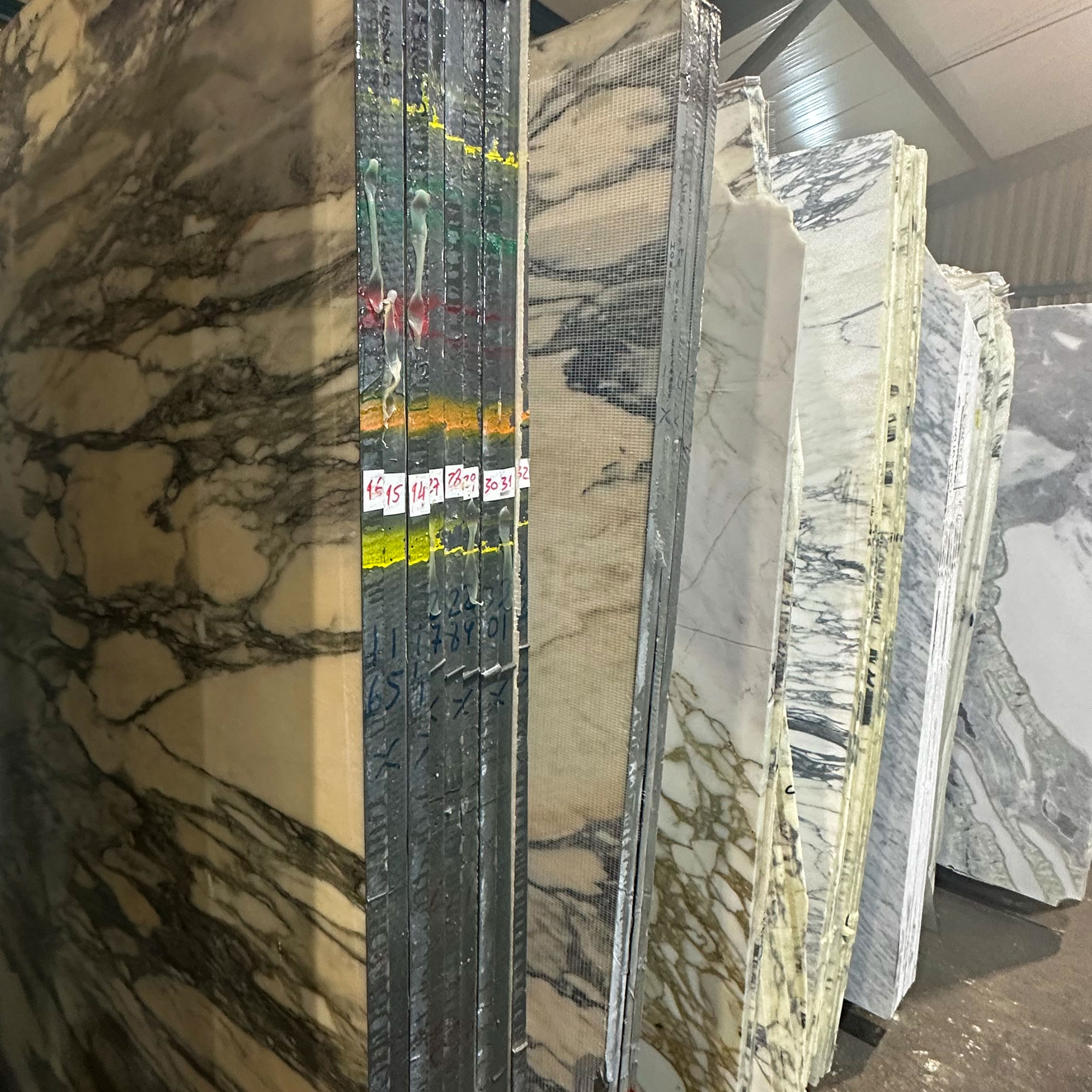 Rows of large slabs of marble in warehouse