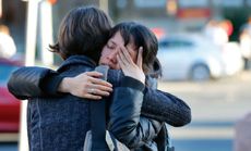 Boston University students hug following a service for graduate student Lu Lingzi, who was killed at the Boston Marathon.
