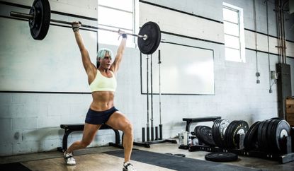 Woman lifting weights in the gym