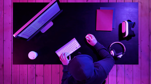 The top 5 Premiere Pro tutorials is represented by a person sat at a computer