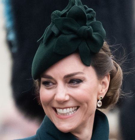 Kate Middleton wearing a green coat and hat and smiling on St. Patrick's Day 2025