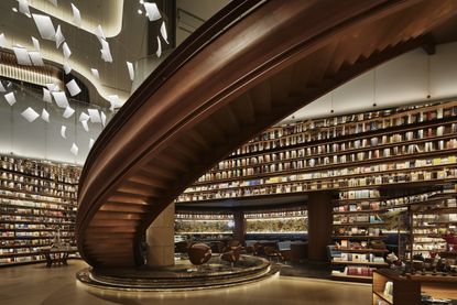 Book store featuring a massive, curved wooden staircase