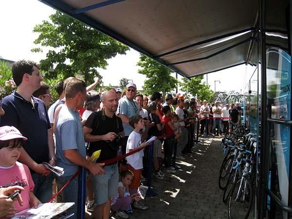 Fans and journalists wait for Lance Armstrong to emerge from his team bus.