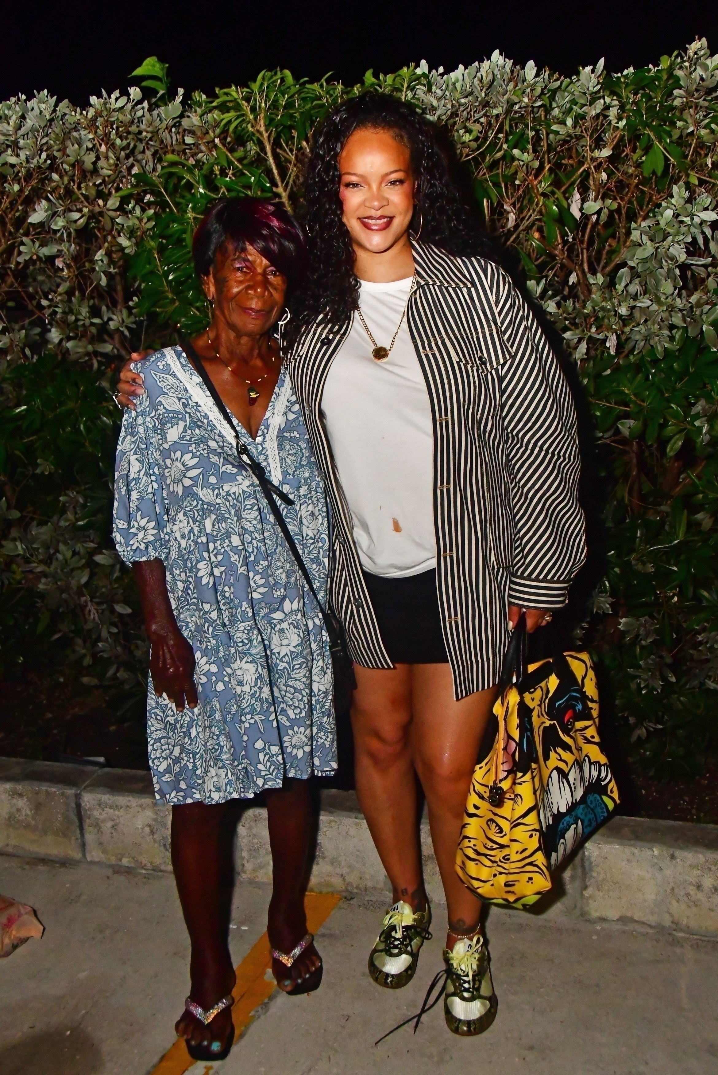 Rihanna was spotted in Barbados wearing Miu Miu snakeskin sneakers and a rare Longchamp Le Pilage bag