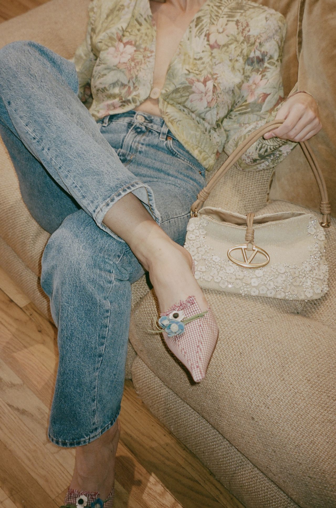 Kathryn Zahorak sitting on couch wearing jeans and gingham heels