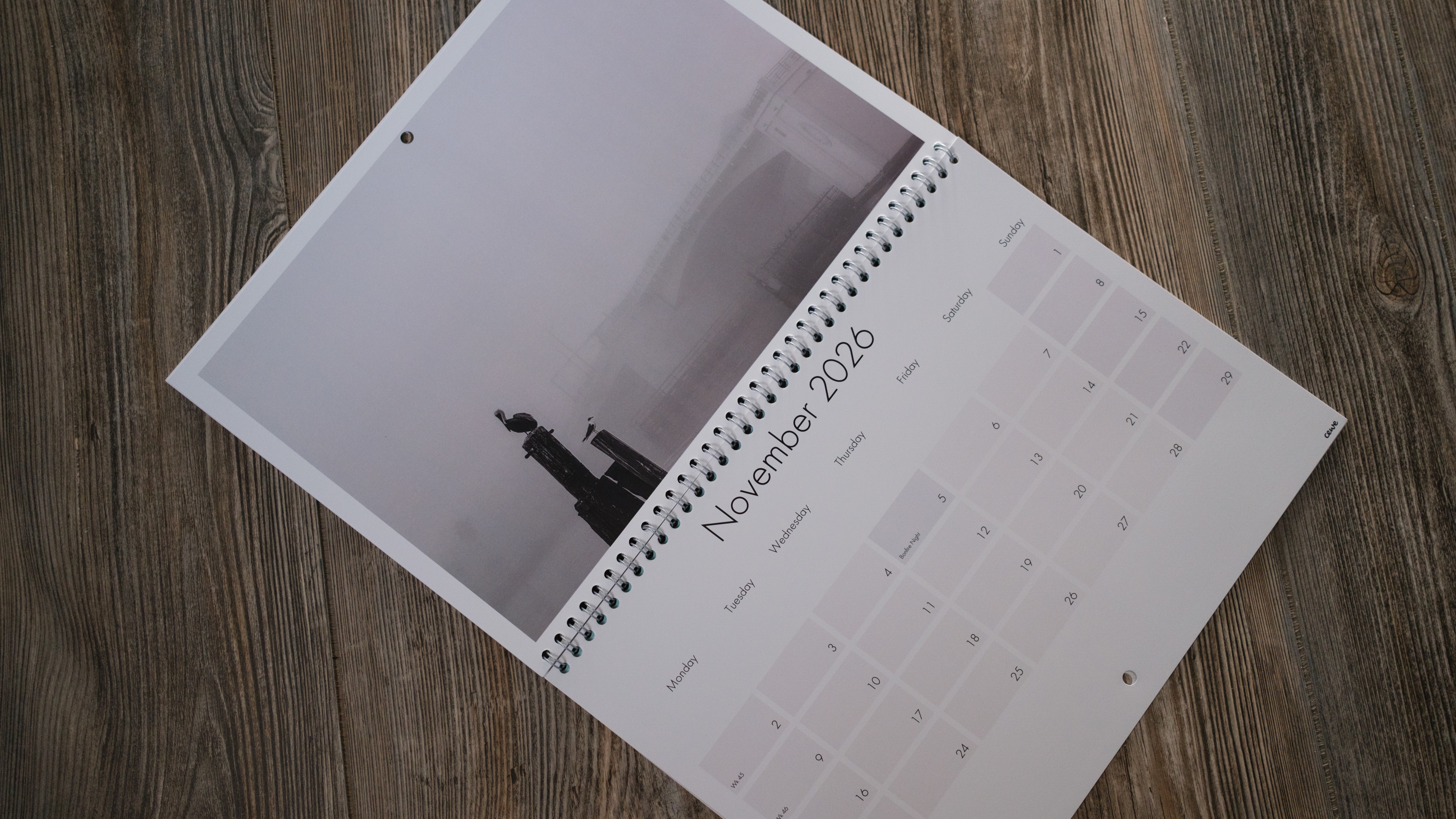A photo calendar from CEWE on a wood background