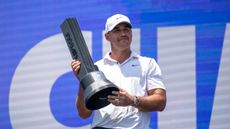 Brooks Koepka proudly holds up the 2024 LIV Golf Singapore trophy after his win at Sentosa Golf Club