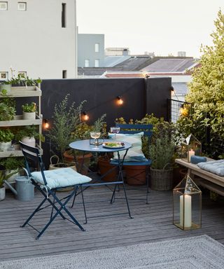 garden with roof terrace and string light decorated with black wall