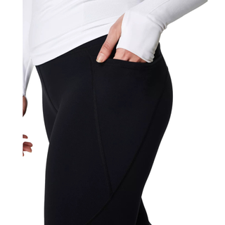 sweaty betty black leggings with pockets woman putting her hand in a side pocket