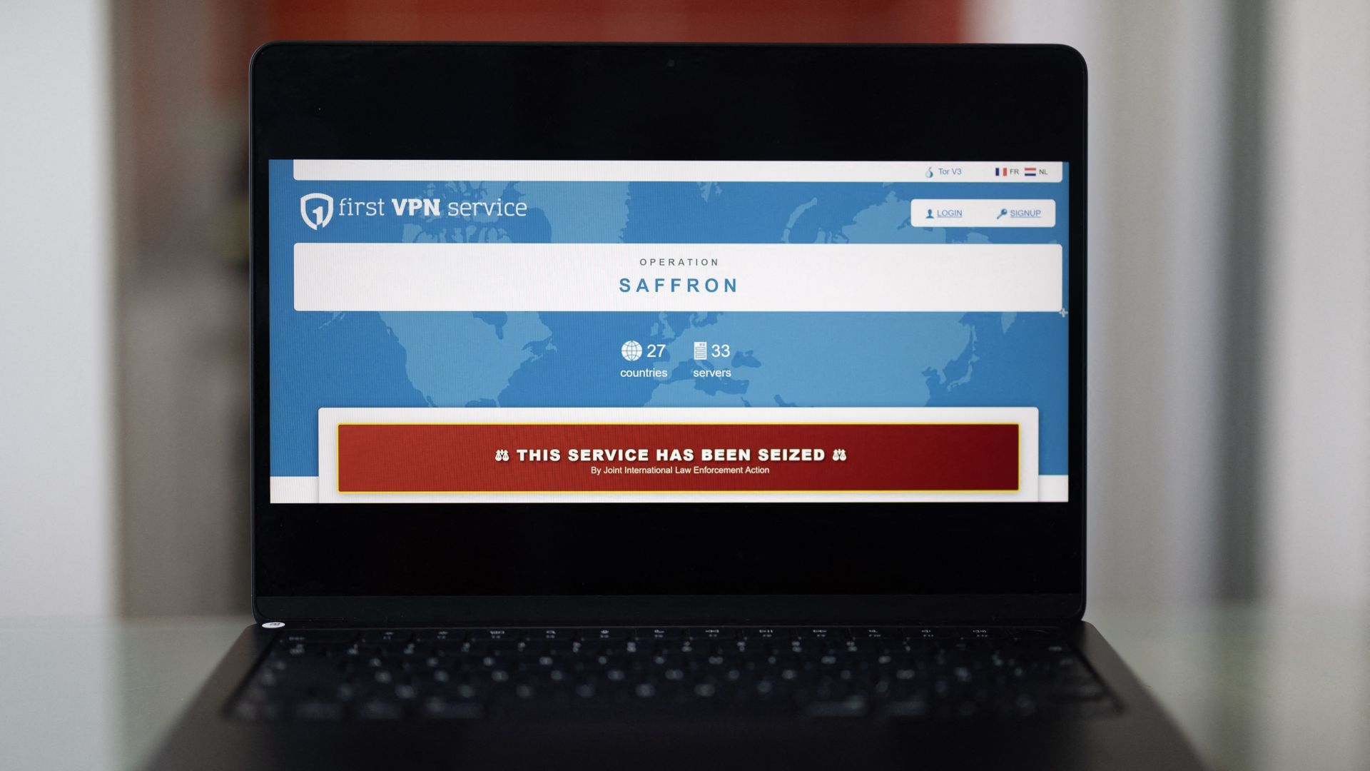 This photograph shows a laptop screen displaying the website of Europol featuring the First VPN service website with a message reading, "This service has been seized"