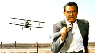 Cary Grant as Roger Thornhill running ahead of an aeroplane in the movie North by Northwest.