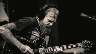 Brent Hinds playing guitar in the studio