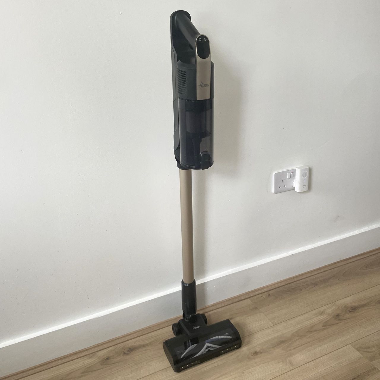 Hoover HF3 Pet DynamicClean Cordless Vacuum Cleaner sitting on wood-effect flooring in front of a white wall