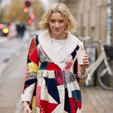 quilted patchwork jacket trend shown on a woman walking down the street 