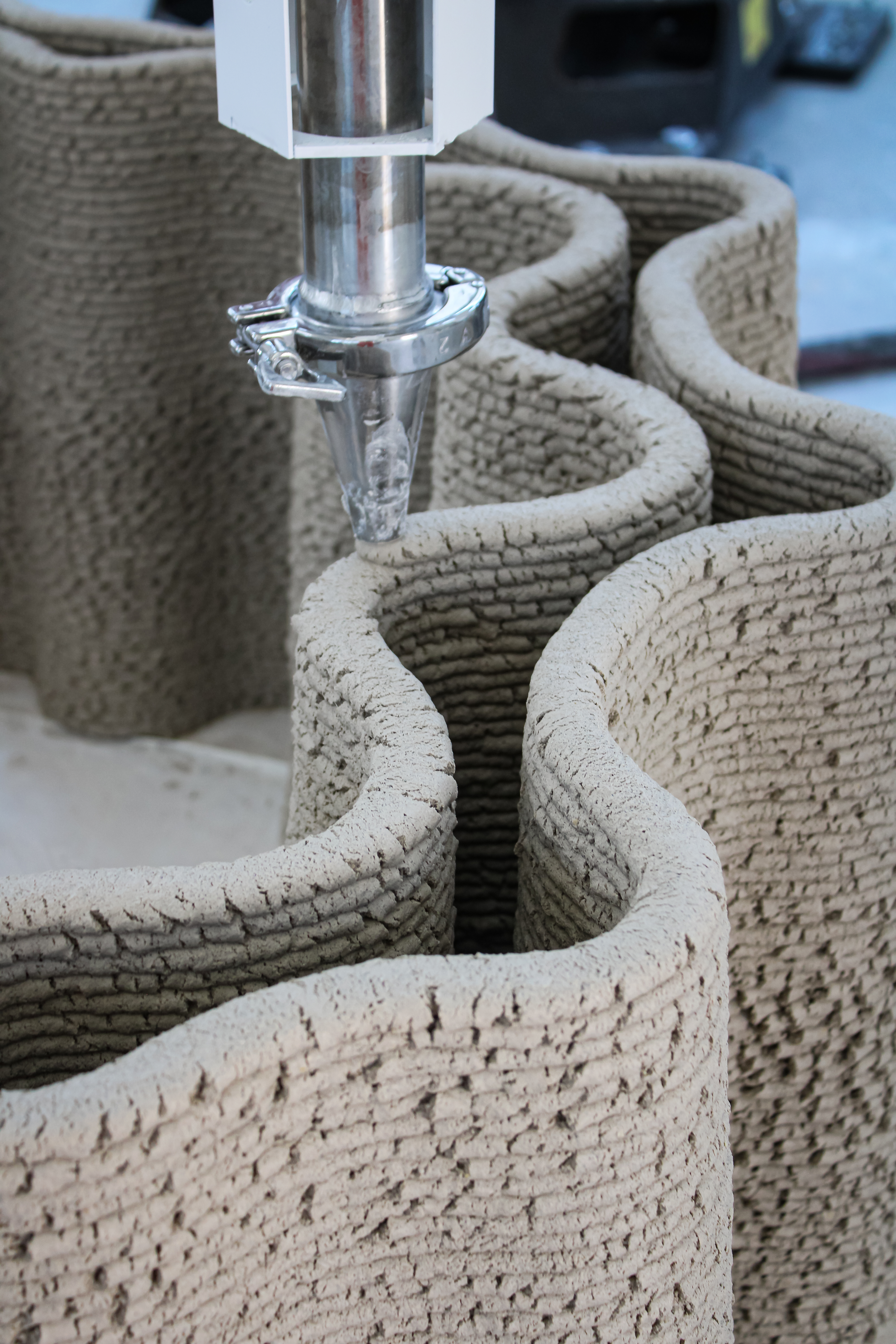 images of the production of Corncretl, a corn based bio alternative to concrete, which is 3D printed