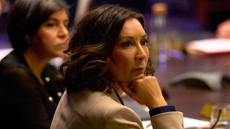 The Baroness Hazarika MBE looks at something across a boardroom table