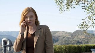 Sarah Snook as Siobhan "Shiv" Roy, standing outside and on the phone, in Succession season 4