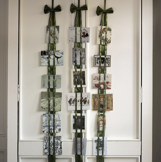 A green organza ribbon used to display Christmas cards on door