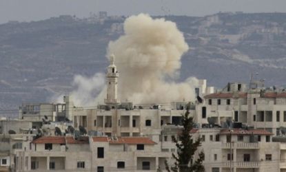 Smoke rises as Idlib city is shelled by Syrian government forces Wednesday.