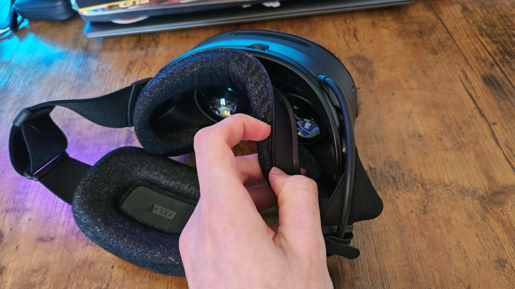 A reviewer peeling the magnetic facial interface of the Steam Frame off