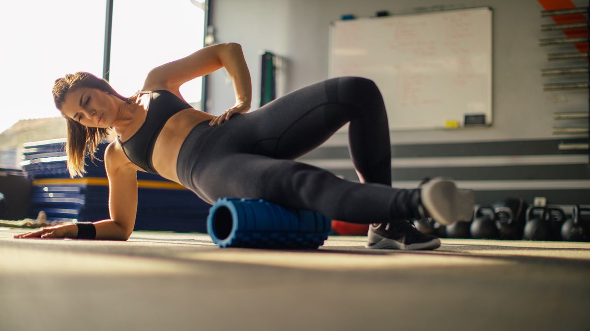 A woman foam rolling