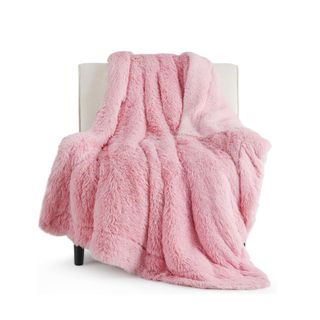 A pink blanket on a white chair