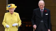 Queen Elizabeth II and Prince Philip, Duke of Edinburgh observe a minute's silence at the start of a garden party at Buckingham Palace on May 23, 2017 in London