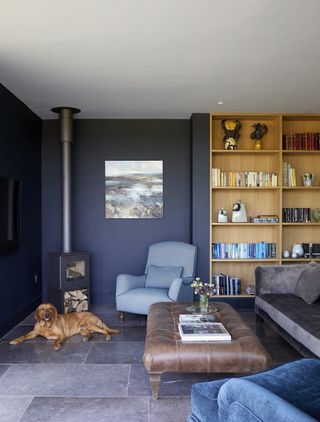 Living room with walls in Zoffany's Ink with light wood bookshelves