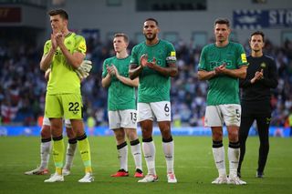 Jamaal Lascelles of Newcastle United and teammates applaud the fans following the team's loss during the Premier League match between Brighton & Hove Albion and Newcastle United at American Express Community Stadium on September 02, 2023 in Brighton, England. (Photo by Steve Bardens/Getty Images)