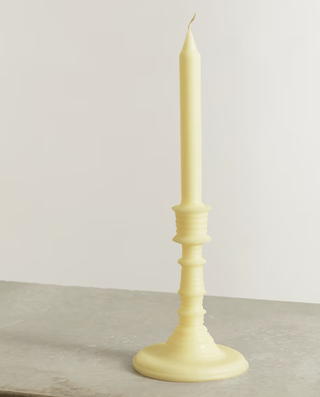 yellow candle in the form of a candlestick and taper candle