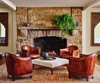 living room with leather club chairs around astone fireplace