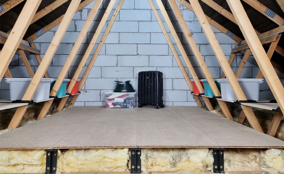 A loft with a raised floor filled with insulation