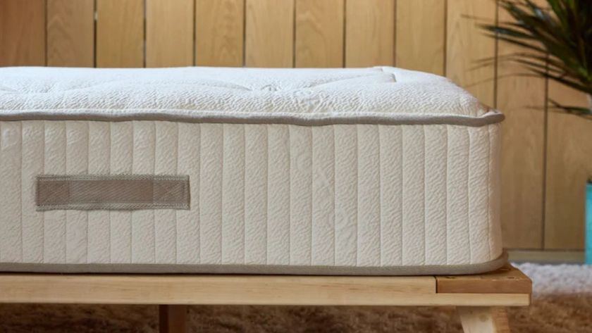 The side of the Avocado Wool mattress showing its paneling and handles sewn on
