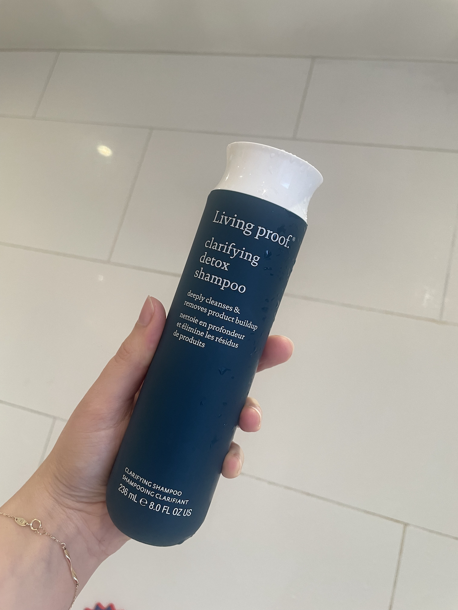 Mica Ricketts holding the Living Proof Detox Shampoo
