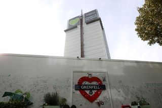Grenfell tower is covered in a safety tarpaulin in west London