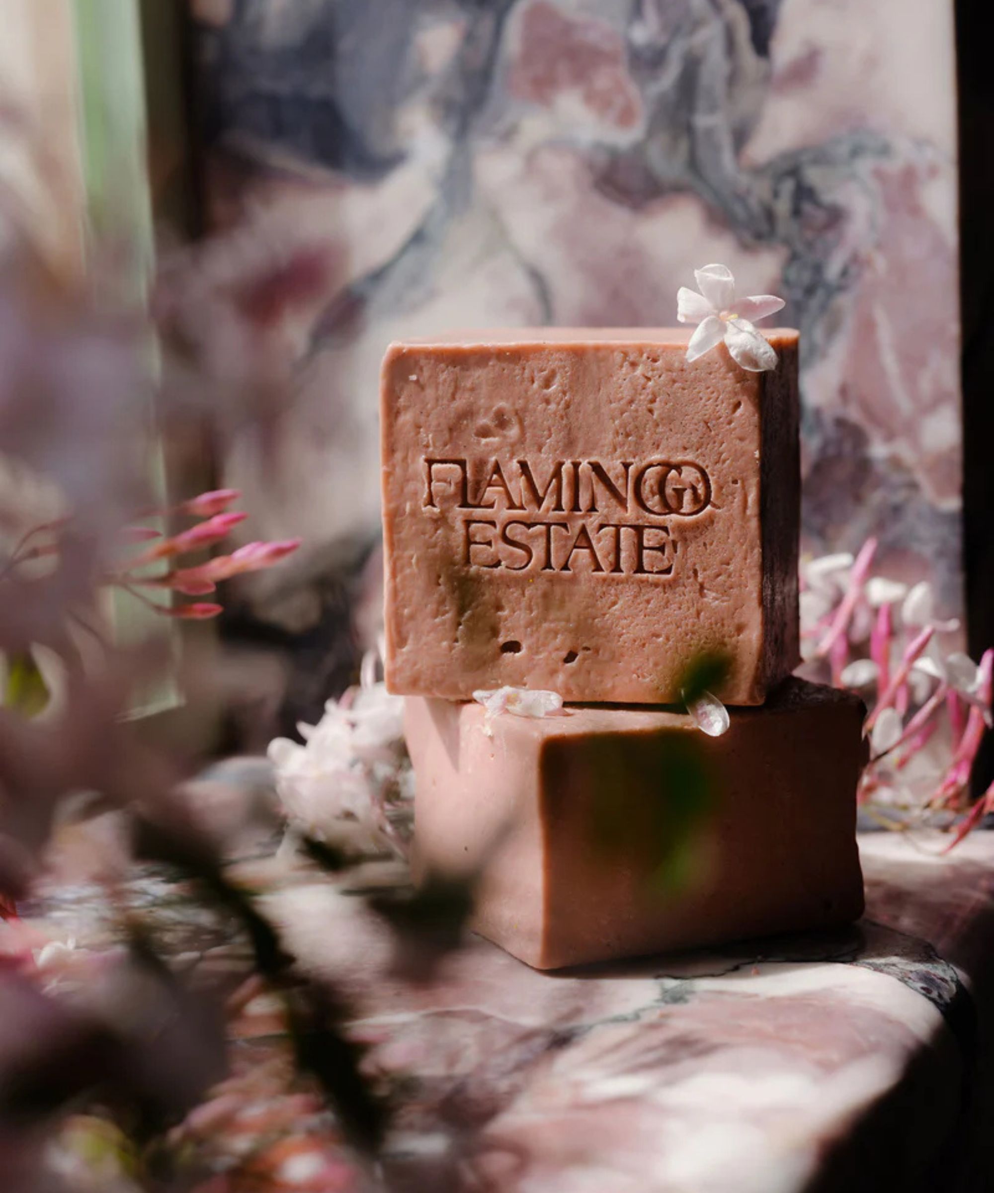 Blocks of Flamingo estate soap with a floral background