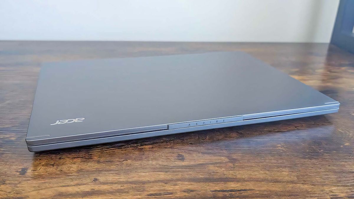 Acer Aspire 14 AI closed on a wooden desk.